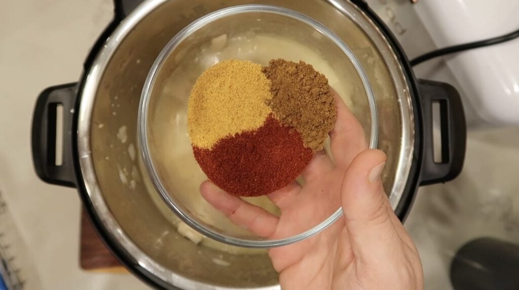 Adding Garam masala, seasoned salt, paprika to pot